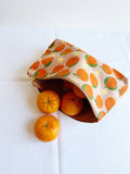 Tangerines on pink. block printed zipper pouch.