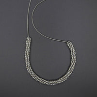 Long silver piano wire necklace with woven silver beads