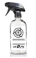 Empty 16 oz. glass spray bottle with a DIY cleaning solution recipe on the label